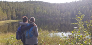 To persons standing by a lake