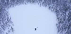 A lake from above with a few people on it