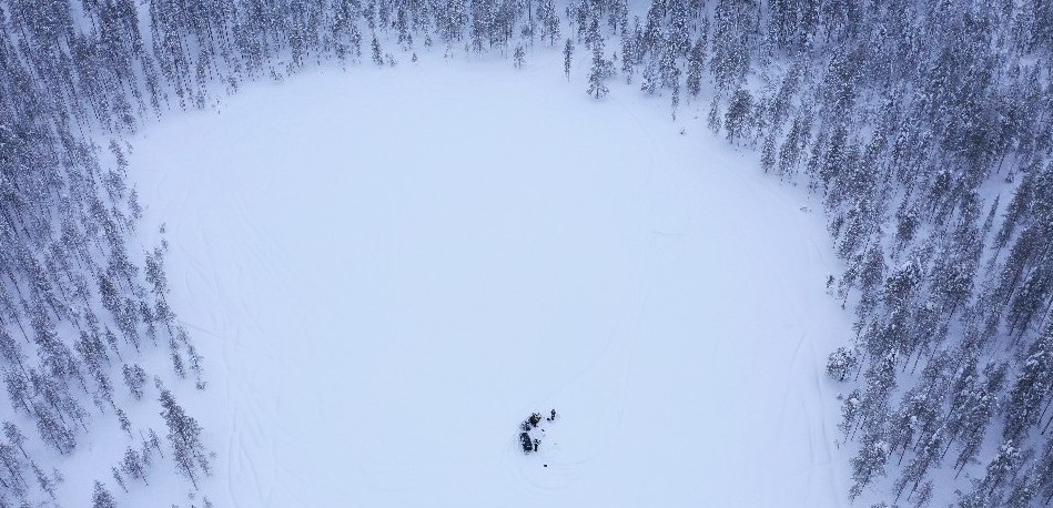 A lake from above with a few people on it
